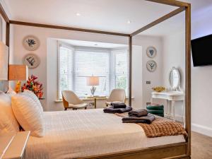 a bedroom with a large bed and a desk at 3 Bed in Shanklin oc-92053 in Shanklin
