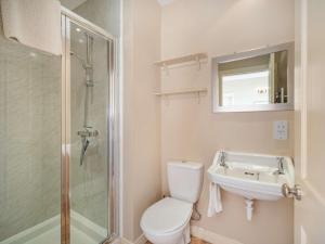 a bathroom with a toilet and a sink and a shower at 4 Bed in Mindrum oc-86272 in Carham +21 photos