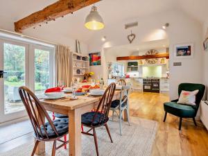 a kitchen and dining room with a table and chairs at 3 Bed in Brockenhurst oc-nfl82 in Beaulieu +20 photos