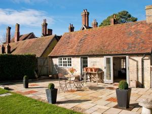 a patio in front of a house with a table at 3 Bed in Brockenhurst oc-nfl82 in Beaulieu