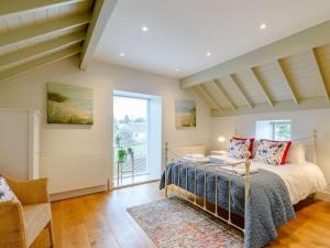 a bedroom with a bed and a large window at 2 Bed in Scarborough oc-82543 in Snainton