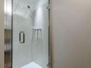 a shower with a glass door in a bathroom at 2 Bed in Scarborough oc-82543 in Snainton