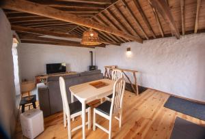 a living room with a table and a couch at Ribeirinha 94 in Ribeirinha