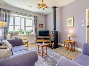 a living room with a couch and a fire place at 2 Bed in Belford oc-92196 in Ellington