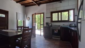 a kitchen with a table and a stove top oven at Duplex La Caleta Mar in Mar de Cobo