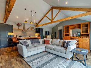 a living room with two couches and a kitchen at 1 Bed in Leeds oc-89862 in Sherburn in Elmet