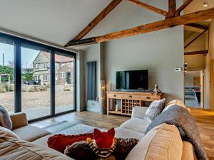 a living room with a couch and a tv at 1 Bed in Leeds oc-89862 in Sherburn in Elmet