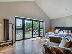 a bedroom with a bed and a large sliding glass door at 1 Bed in Leeds oc-89862 in Sherburn in Elmet