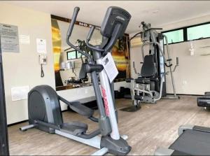 a gym with two tread machines and a treadmill at Um lar aconchegante na rota do sol in Natal