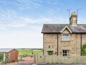 a stone house with a fence and a field at 3 Bed in Belford oc-cn022 in Smeafield