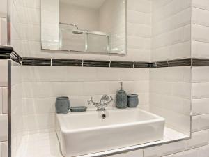 a white bathroom with a sink and a mirror at 3 Bed in Belford oc-cn022 in Smeafield +23 photos
