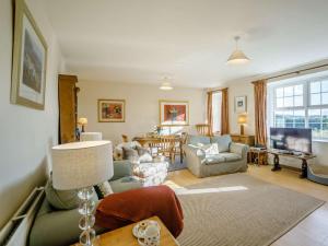 a living room with a couch and a table at 2 Bed in Mindrum oc-85422 in Carham