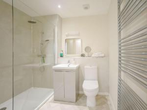 a bathroom with a toilet and a shower and a sink at 2 Bed in Mindrum oc-85422 in Carham +18 photos
