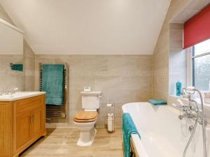 a bathroom with a tub and a toilet and a sink at 1 Bed in Chard oc-91135 in Cudworth +8 photos