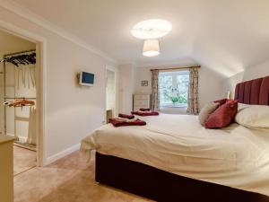 a bedroom with a large bed with red pillows at 1 Bed in Chard oc-91135 in Cudworth