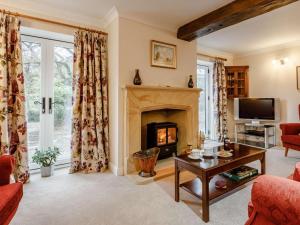 a living room with a fireplace and a tv at 1 Bed in Chard oc-91135 in Cudworth