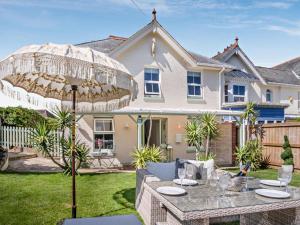 a patio with a table and an umbrella in front of a house at 3 Bed in Shanklin oc-92052 in Shanklin