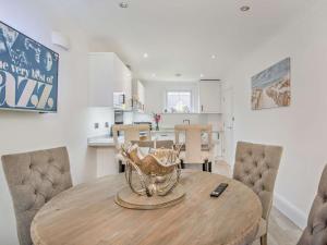 a kitchen and dining room with a wooden table and chairs at 3 Bed in Shanklin oc-92052 in Shanklin