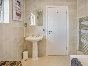 a white bathroom with a sink and a mirror at 3 Bed in Shanklin oc-92052 in Shanklin +23 photos