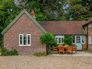 a brick house with a table and chairs in front of it at 4 Bed in Salisbury oc-82799 in Winchester