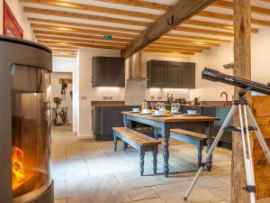 a camera in a kitchen with a table and a stove at 4 Bed in Hexham oc-78159 in Catton