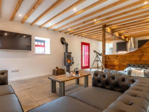 a living room with a couch and a table at 4 Bed in Hexham oc-78159 in Catton