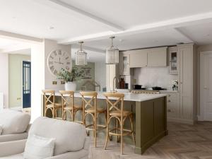 a kitchen with a large island with bar stools at 5 Bed in Lymington oc-96189 in Sway