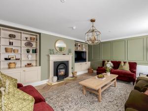 a living room with a couch and a fireplace at 5 Bed in Lymington oc-96189 in Sway