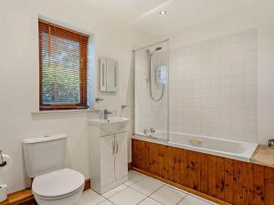a bathroom with a toilet and a sink and a tub at 3 Bed in Wareham oc-dc157 in Stoborough +9 photos