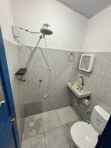 a bathroom with a shower with a toilet and a sink at Hotel D'Aldeia Cametá in Cametá