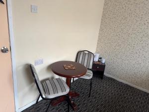 a room with a small table and two chairs at The Clarendon Hotel in Blackpool