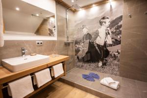 a bathroom with a sink and a mirror at Gästehaus Felder in Hirschegg +78 photos