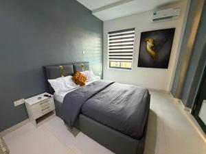 a bedroom with a bed with a stuffed animal on it at Max Heights in Ikeja +44 photos