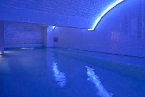 a pool of water in a room with blue lights at Harbour Hotel & Spa Bristol in Bristol