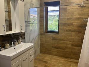 a bathroom with a sink and a shower at Waterfall home in Yerevan +8 photos