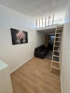 a living room with a ladder and a couch at VILLA Papillon , maison entière avec jardin in Champigny-sur-Marne