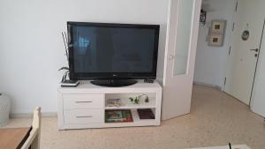 a tv on a white cabinet with a television on it at Aguadulce Beach in Aguadulce