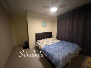 a bedroom with a bed and a ceiling fan at Sri Nabalu Apartment Platinum Putatan in Kota Kinabalu