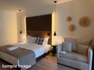 a bedroom with a large bed and a couch at ROBINSON BOA VISTA - All inclusive in Sal Rei +26 photos