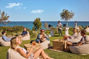 a group of people sitting in chairs on the grass at ROBINSON BOA VISTA - All inclusive in Sal Rei