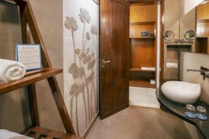 a small bathroom with a toilet and a sink at Anantya At Anamiva in North goa +29 photos