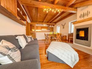 a living room with a couch and a fireplace at Belvedere Solferino panoramic view in Campolongo