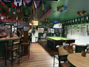 a bar with a pool table and tables and chairs at DUCK INN AND RESTAURANT in Manila