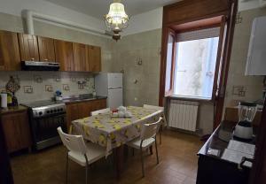 a kitchen with a table with chairs and a table cloth at Rosa Dei Venti in Amalfi