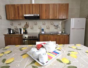 a kitchen with a table with a tray with tea cups at Rosa Dei Venti in Amalfi +10 photos