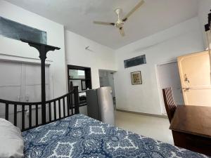 a bedroom with a bed and a ceiling fan at Nadya Homestay For Female & family in Jaipur +192 photos