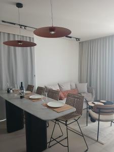 a living room with a table with chairs and a couch at Amor Club Luxury Suite in Eilat +2 photos