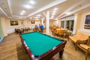 a pool table in a room with tables and chairs at Bieno Venüs Hotel - All Inclusive in Side
