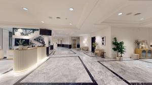 a lobby of a hotel with a large marble floor at AZZ Mérida Medea Hotel in Mérida +62 photos