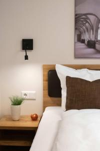 a bedroom with a bed with a tv on the wall at Einzelzimmer 8 in Heidenheim